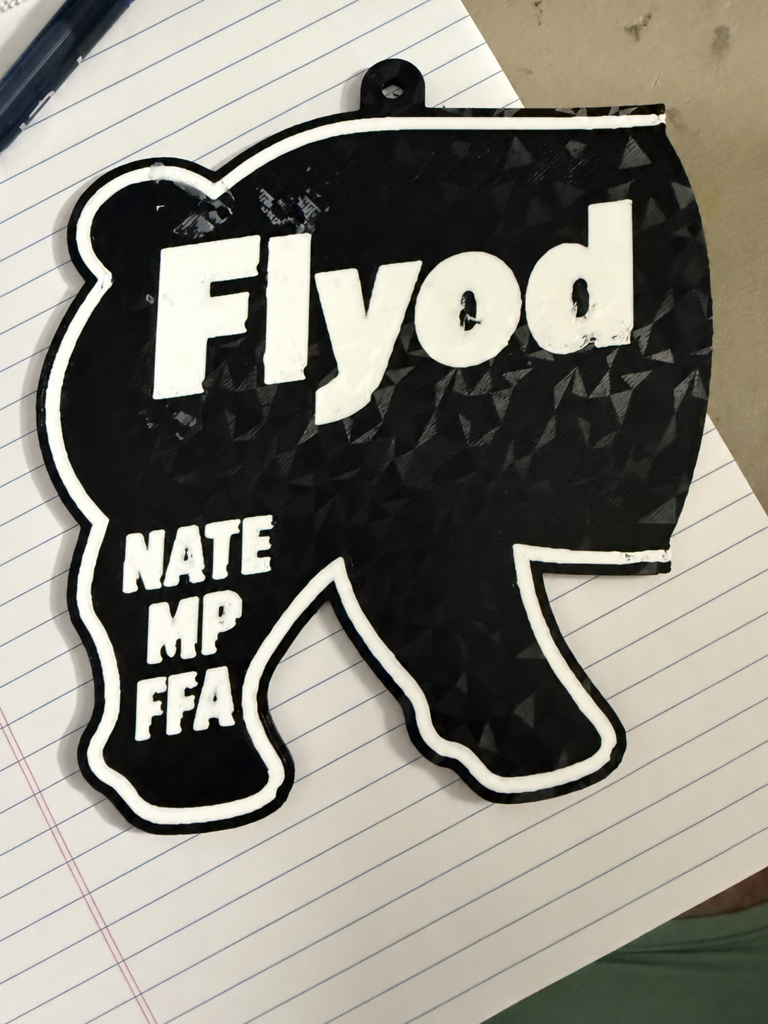 First black-and-white hog-shaped test print, with uneven lettering and outline.