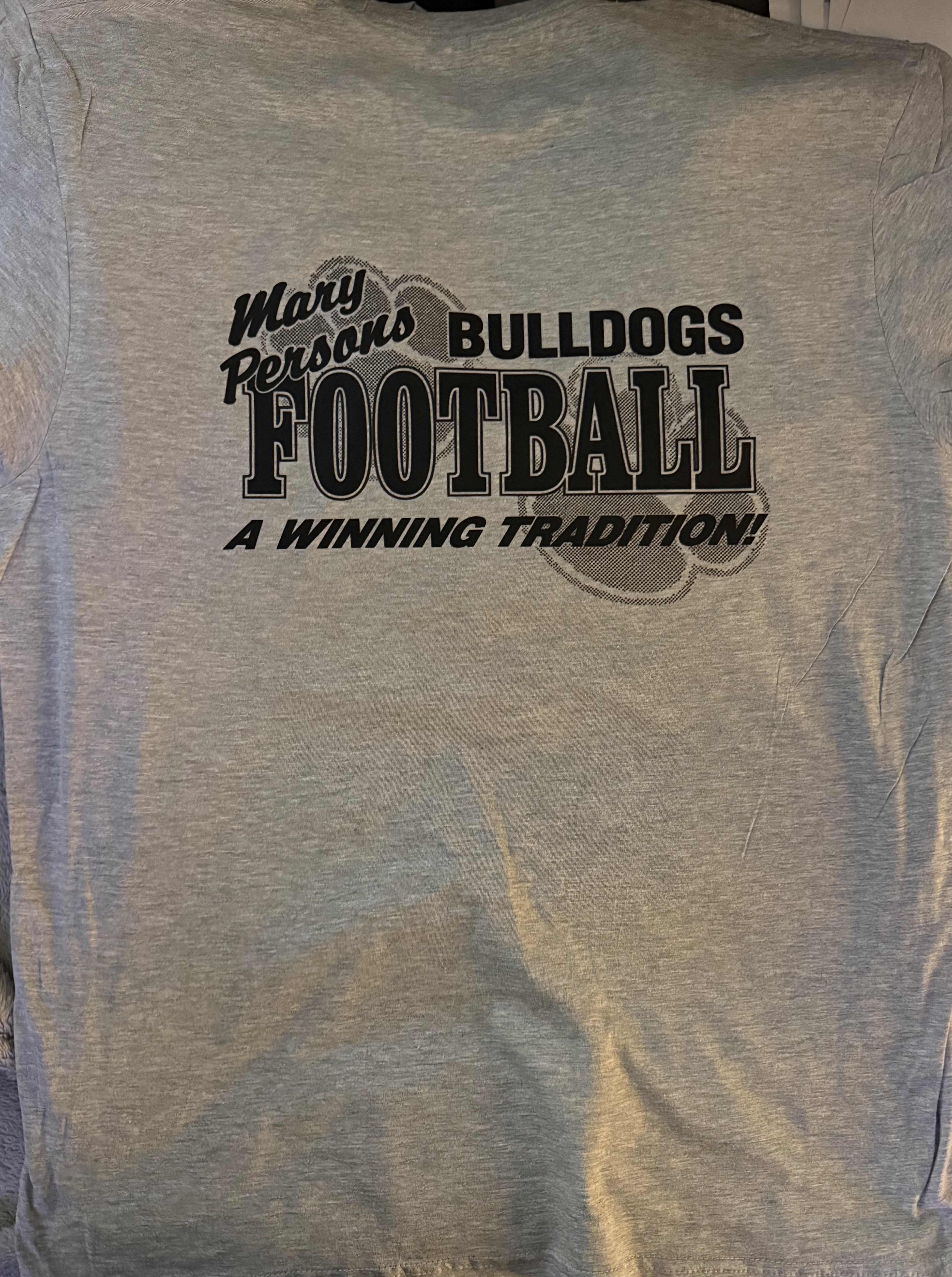 Gray shirt replicated by Crab Apple Orchards Customs with Mary Persons Bulldogs Football lettering, a paw print, and A Winning Tradition.